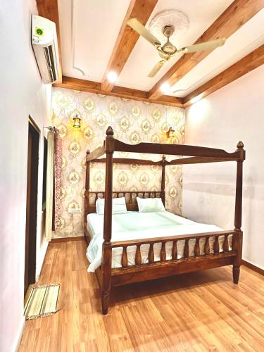a bedroom with a wooden bed in a room at The Kandarp Villa in Jaipur