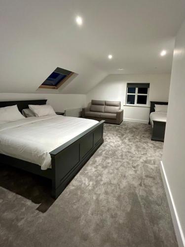 a bedroom with a large bed and a couch at Modern house Boyle in Boyle