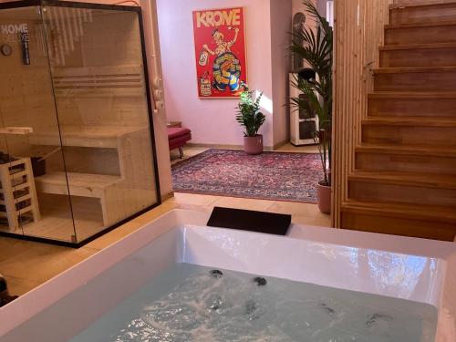 a large bath tub in a room with a shower at Waldchalet in Burgthann