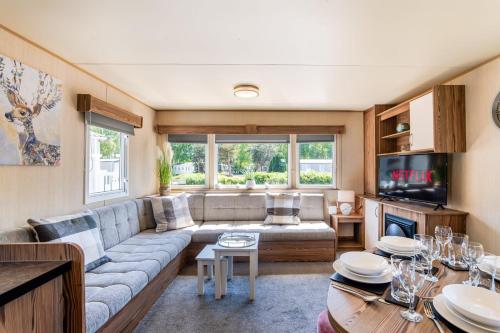 a living room with a couch and a tv at Coastal Caravan at Seton Sands -Near Edinburgh in Port Seton