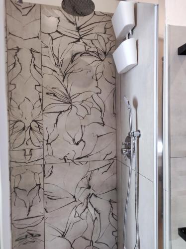 a bathroom with a shower with a black and white wallpaper at 50 Special in Pontedera
