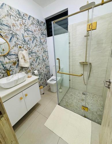 a bathroom with a shower and a toilet at Villa Le Caprice in Grand-Baie