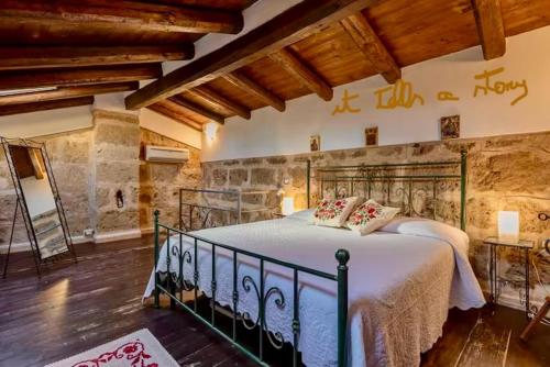 a bedroom with a large bed in a room at Emerald apartment in Alghero Historic Center in Alghero