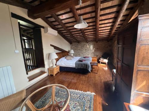 a bedroom with a bed and a stone wall at Mas Maimes in Agullana