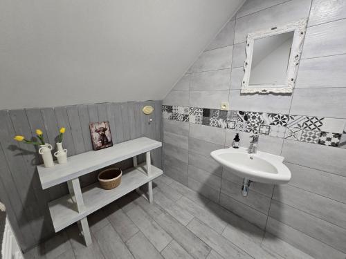 a bathroom with a sink and a mirror at Prostě statek in Skalka
