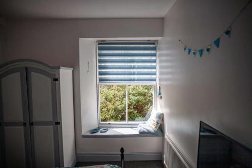 a window with a window seat in a room at Verity and Ilfracombe Harbour View in Barnstaple