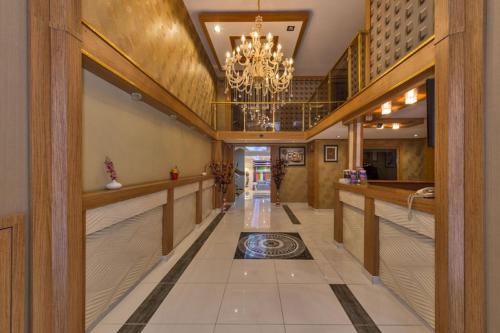 a hallway with a chandelier and a hallway with a floor at Hotel Selenay in Istanbul