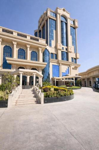 a large building with stairs in front of it at Grand Tibarose Hotel in Cairo