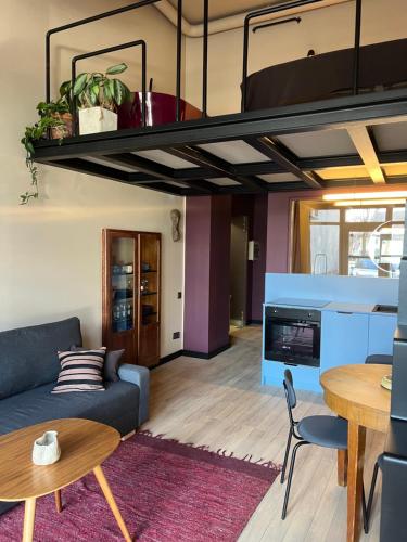 a living room with a couch and a loft at G Loft - Spacious Urban Apartment with Bathtub and Private Entrance in Kaunas