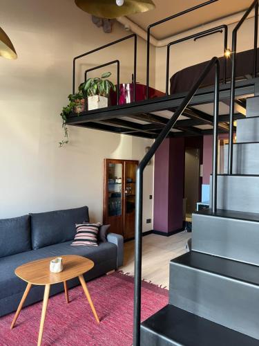 a living room with a couch and a loft bed at G Loft - Spacious Urban Apartment with Bathtub and Private Entrance in Kaunas