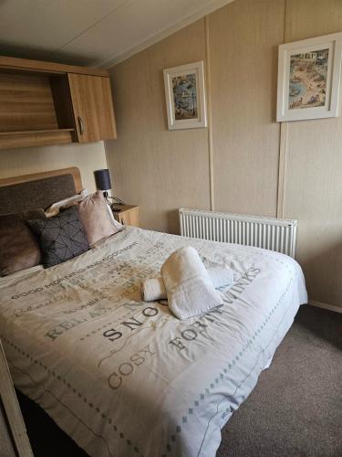 a bedroom with a large bed with pillows on it at Stunning modern lodge in Port Seton