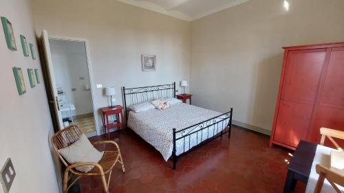 a bedroom with a bed and a chair at Cascina Barosca in Castelnuovo Don Bosco