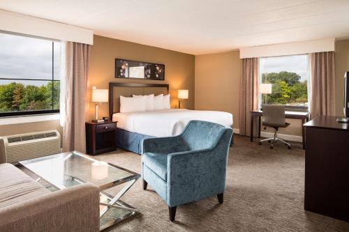 a hotel room with a bed and a chair and a desk at DoubleTree by Hilton Hotel Laurel in Laurel