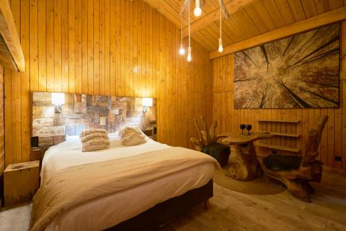 a bedroom with a bed in a wooden room at Les cottages du parc in Roubaix