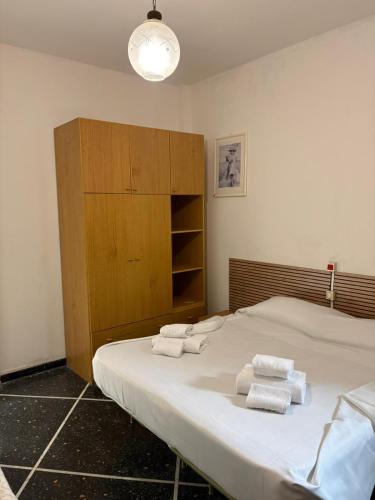 a bedroom with a large bed with towels on it at Hotel & Trattoria Le Caravelle in Lavagna