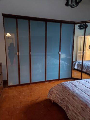 a bedroom with glass walls and a bed in it at Maison Platone Jolie in Alessandria