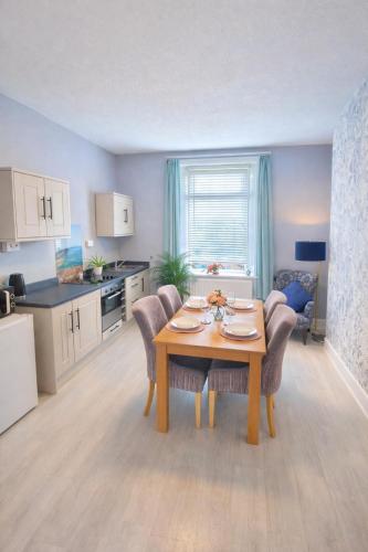 a kitchen and dining room with a table and chairs at Sea Thrift Nook Amble in Amble