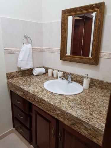 a bathroom with a sink and a mirror at 2BR Condo with Pool, Walk to Beach, Bvaro in Punta Cana