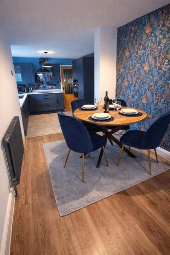 a dining room with a table and chairs and a kitchen at Cambois beach Maisonette with sea view! in Cambois