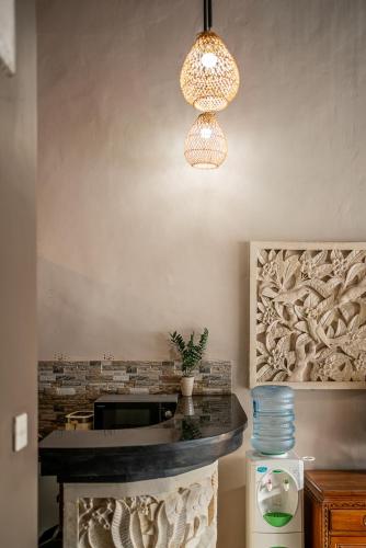 a kitchen with a counter and aendant light at Villa Papat Seminyak in Seminyak