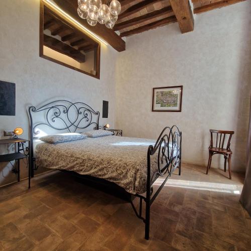 a bedroom with a bed and a chandelier at Domus Calzolari in Gubbio