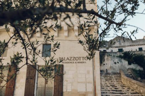 a building with stairs in front of a castle at Il Palazzotto I Residence & Winery in Matera