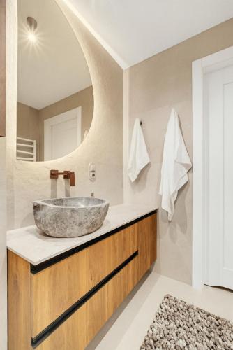 a bathroom with a sink and a mirror at Neon Apartments Centrum in Częstochowa