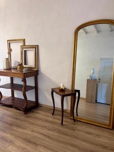 a mirror and a table and a table with a mirror at Palazzo Calderini in Castiglion Fiorentino
