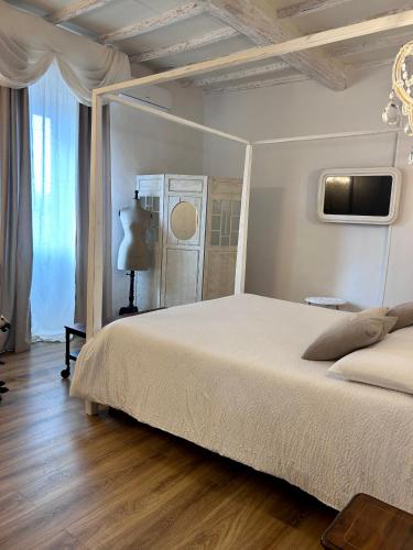 a bedroom with a bed and a tv on the wall at Palazzo Calderini in Castiglion Fiorentino