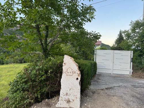 a rock with writing on it next to a white fence at CASA DI BETTA Appartamento 3 Ascoli, Norcia, Monti Sibillini in Piana di Forcella