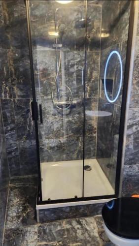 a shower with a glass door in a bathroom at Private room in the centre of Tilburg in Tilburg