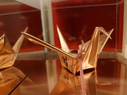 a pair of shoes in a glass display case at the UNIT5 HOUSE Roppongi in Tokyo