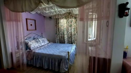 a bedroom with a bed and a window at Elizas house in Nea Makri