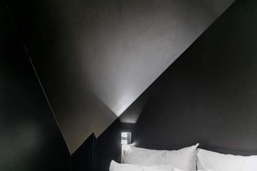 a room with two beds with white pillows at Pytloun Imperial Design Suites in Liberec