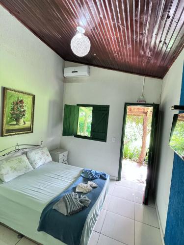 a bedroom with a bed with a wooden ceiling at Eco Charme da Bodoquena in Bodoquena