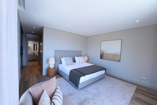 a bedroom with a king sized bed and a couch at Villa Macedo in Ponta do Sol