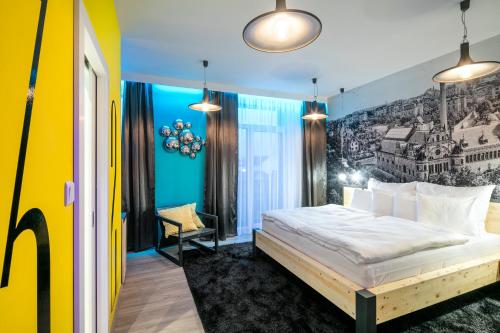 a bedroom with a bed and a painting on the wall at Pytloun Imperial Design Suites in Liberec