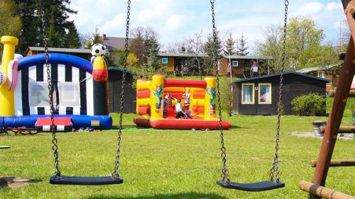a park with a playground with slides and swings at Camping Przywidz - Mała Szwajcaria in Przywidz
