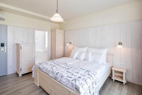 a bedroom with a large white bed and a window at Pytloun Imperial Design Suites in Liberec