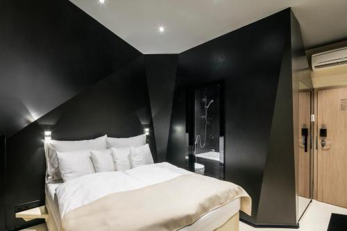 a black and white bedroom with a large bed at Pytloun Imperial Design Suites in Liberec
