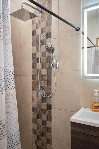 a bathroom with a shower and a sink at Los Cipreses Eco Hotel in Sonsonate