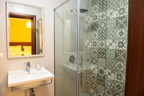a bathroom with a sink and a shower at Hotel Vila Bregu in Tirana