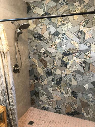 a bathroom with a shower with a mosaic tile wall at A Private Paradise by the Rainforest in Luquillo