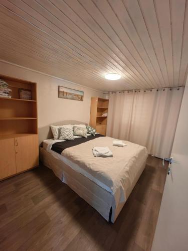 a bedroom with a large bed with a ceiling at Kril in Remniku