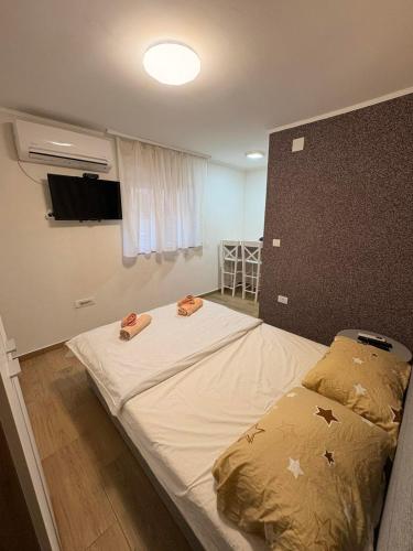 a bedroom with a large bed with two towels on it at Dream 3 in Vračar (historical)
