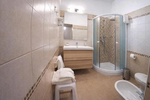 a bathroom with a sink and a toilet and a shower at Villa Merina in Vieste