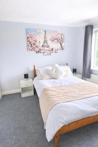 a bedroom with a bed and a tower on the wall at Bedlington 3 bed house in Bedlington