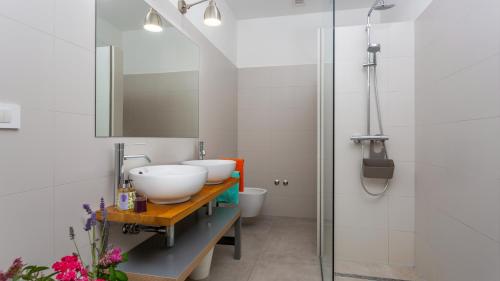 a bathroom with two sinks and a shower at Casa Tijana by Villas Guide in Krk