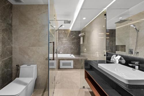 a bathroom with a sink and a toilet and a shower at The Turtle Hotel Bangsaen in Ban Thai Don (1)