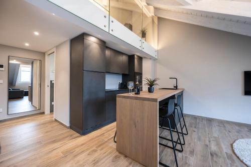 a kitchen with a wooden island in a room at Ariel Penthouse - In the heart of Domodossola in Domodossola